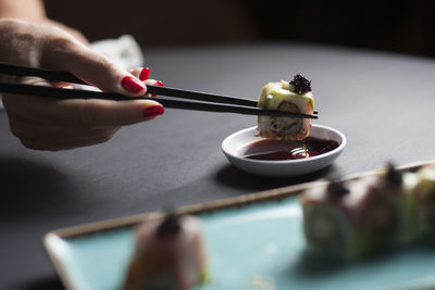 Close-up of person preparing food on table