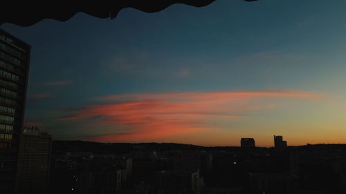 Silhouette buildings against sky during sunset