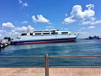 Ship moored on sea against sky