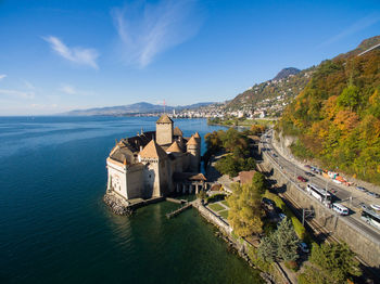 High angle view of buildings by sea against sky