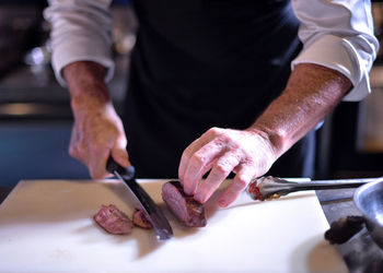 Midsection of man preparing food