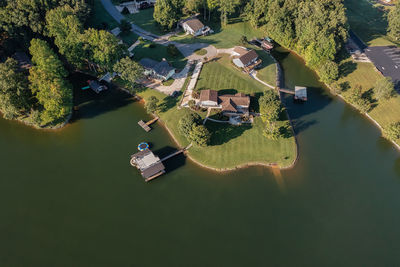 Aerial view of lakefront homes and floating boat docks with upper deck and slide on tims ford lake.