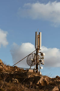 Low angle view of communications tower against sky