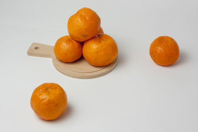High angle view of orange fruit on white background