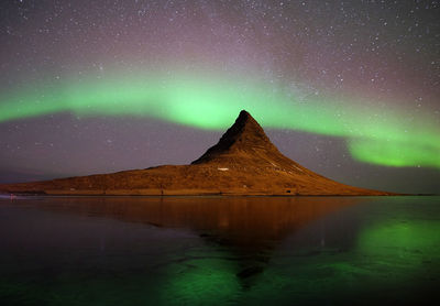 Scenic view of lake against sky at night