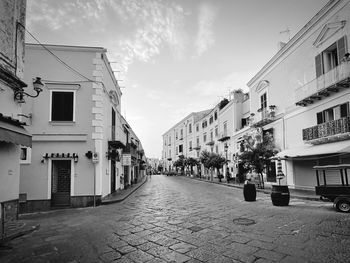 Street amidst buildings against sky