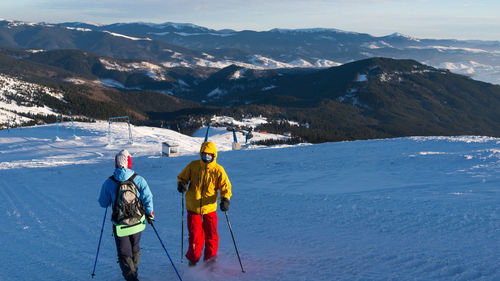 People skiing on snowcapped mountain