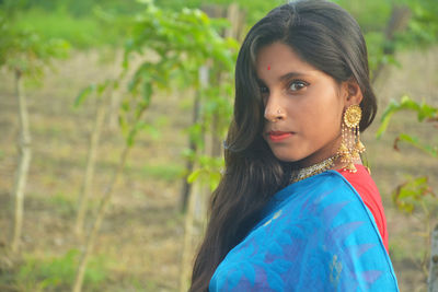 Portrait of girl wearing sari standing outdoors