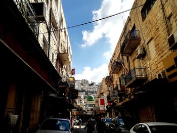 View of city street and buildings against sky