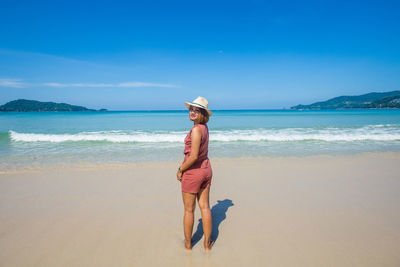 Portrait of woman standing at beach
 