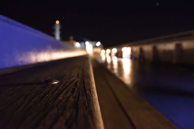 Close-up of illuminated bridge against sky at night