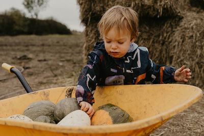 Portrait of cute girl sitting on field