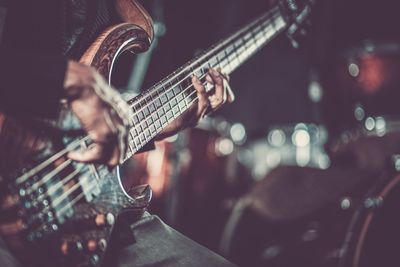 Close-up of man playing guitar