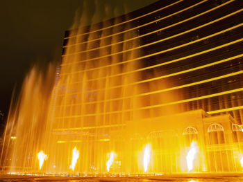 Low angle view of illuminated ferris wheel at night