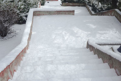 High angle view of steps on snow covered field