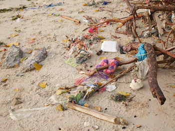 High angle view of garbage on sand