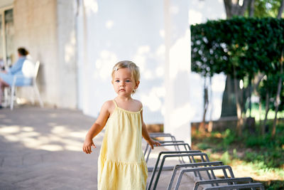 Portrait of smiling girl standing outdoors