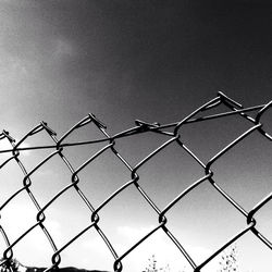 Low angle view of chainlink fence against clear sky