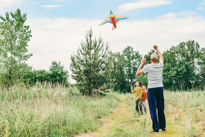 Dad and sons let a kite in the street. happy childhood with dad. active games on the street. 