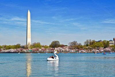 People in boat against sky