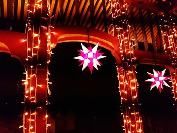 Low angle view of illuminated christmas lights at night