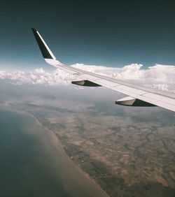 Aerial view of airplane flying in sky