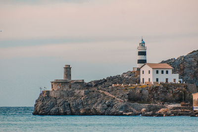 Building by sea against sky