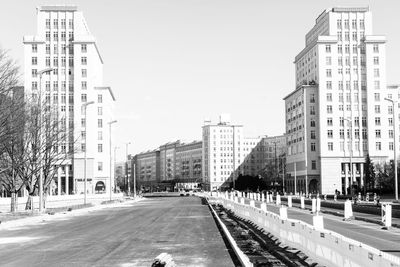 City street and buildings against sky