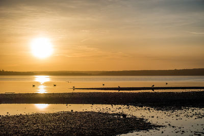 Scenic view of sea against sky at sunset