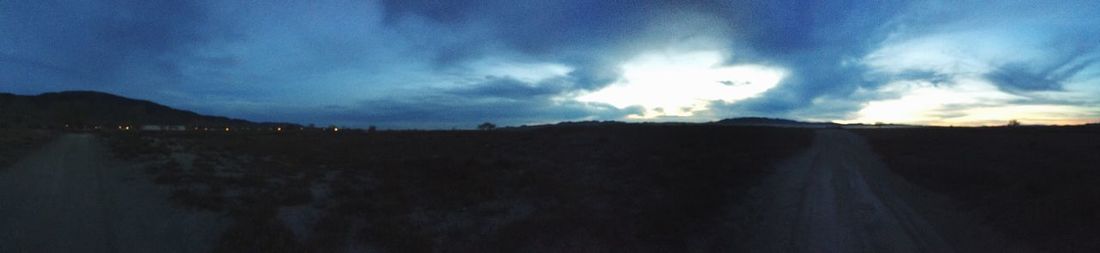 Scenic view of landscape against cloudy sky