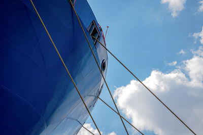 Low angle view of sailboat against blue sky