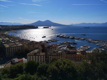 High angle view of townscape by sea against sky