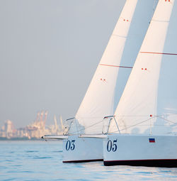 Sailboat sailing on sea against clear sky