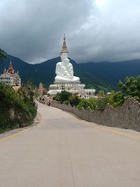 View of road amidst buildings against sky