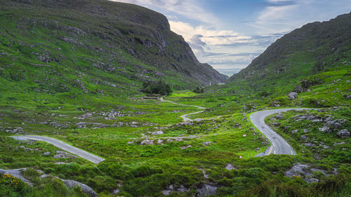 Beautiful landscape with winding narrow road running through gap of dunloe and black valley, ireland