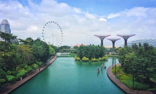 Scenic view of river by trees against sky