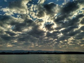 Scenic view of lake against dramatic sky