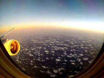 Cropped image of airplane wing over landscape