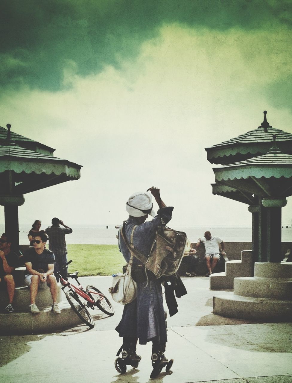 lifestyles, leisure activity, men, sky, sea, person, water, large group of people, rear view, togetherness, beach, cloud - sky, vacations, horizon over water, full length, casual clothing, standing, travel, sitting