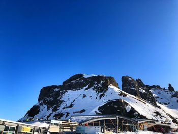 Scenic view of snowcapped mountains against clear blue sky