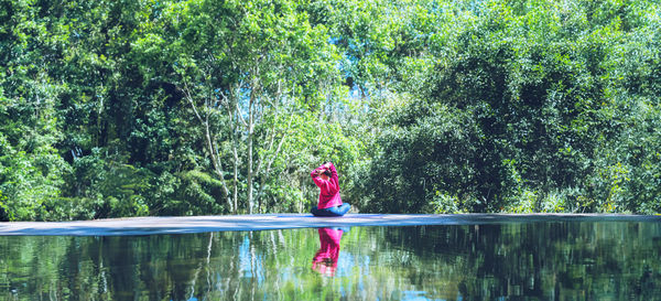 Rear view of woman standing in lake