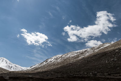 Low angle view of snowcapped mountain against sky