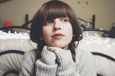 Portrait of young woman sitting on table