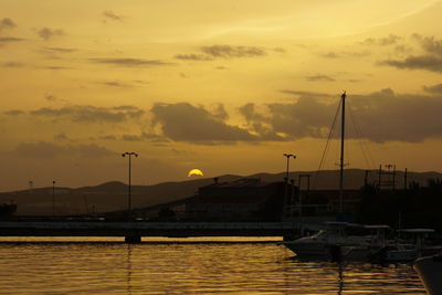 Boat in sea at sunset