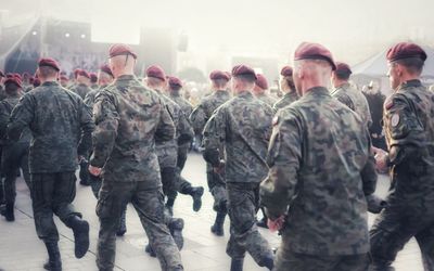 Soldiers running on footpath