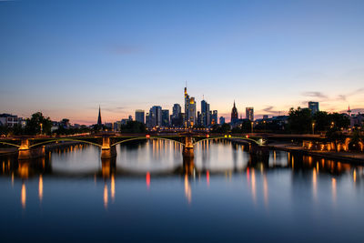 Illuminated buildings in city at waterfront