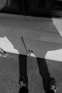 Shadow of person on road