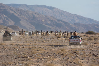 People on landscape against mountains