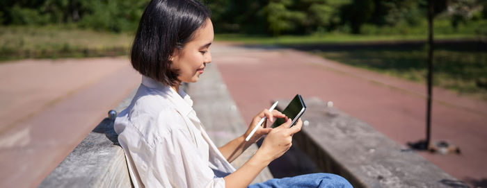 Young woman using mobile phone