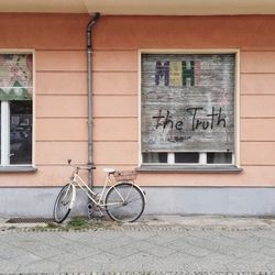 Bicycle parked against building